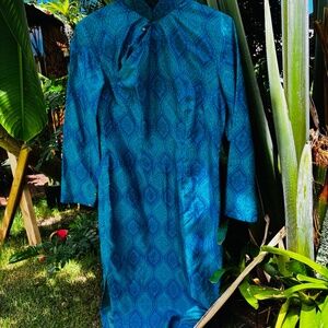 Turquoise/teal long sleeve dress with crossover neckline, side zipper and slits.